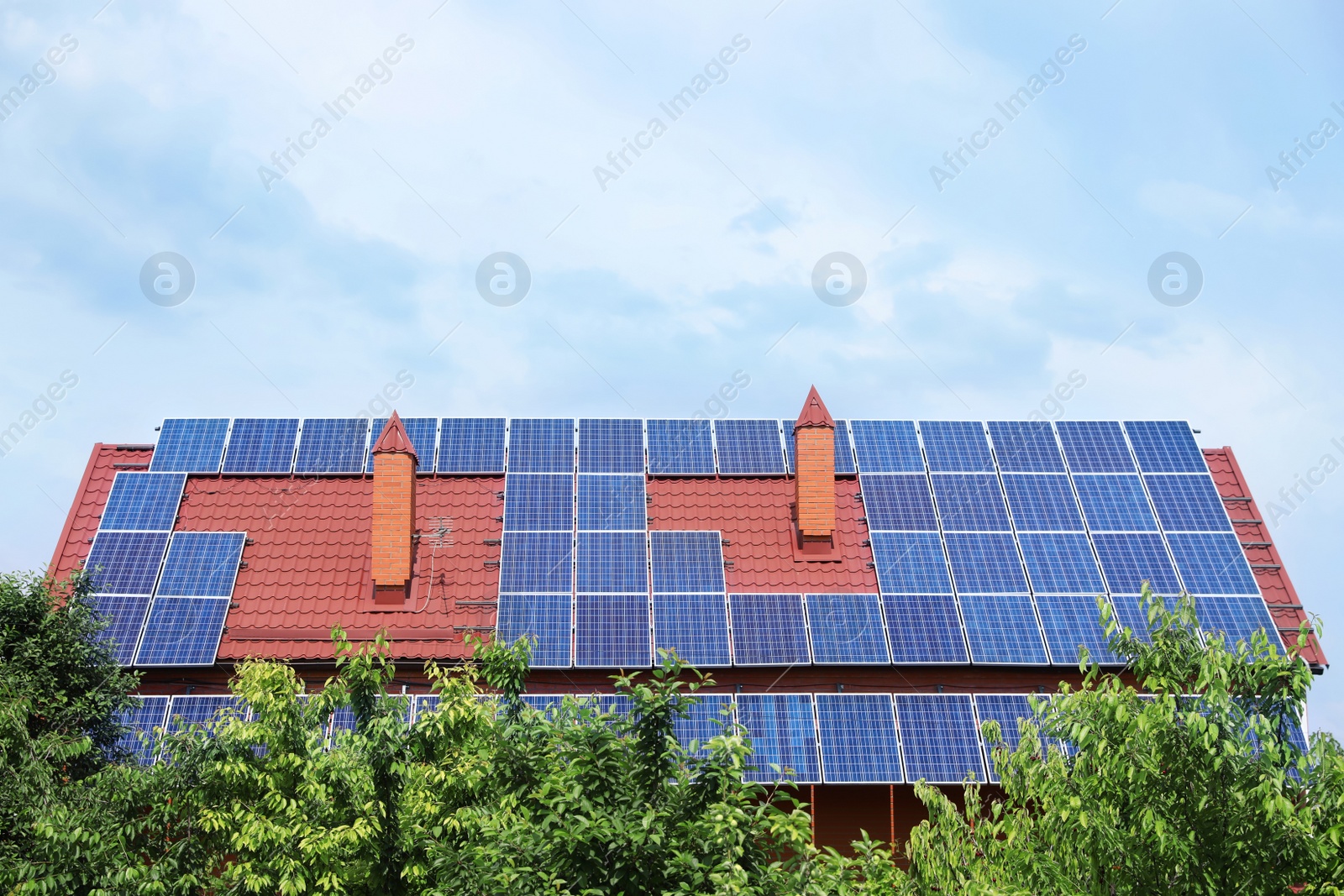 Photo of House with installed solar panels on roof. Alternative energy source