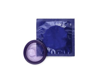 Unpacked condom and package on white background, top view. Safe sex