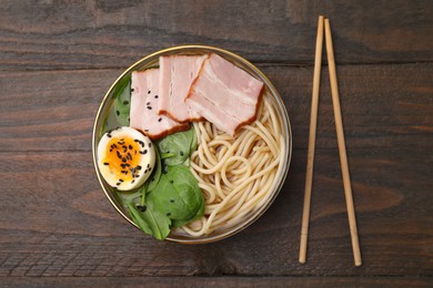 Photo of Delicious ramen with meat on wooden table, flat lay. Noodle soup