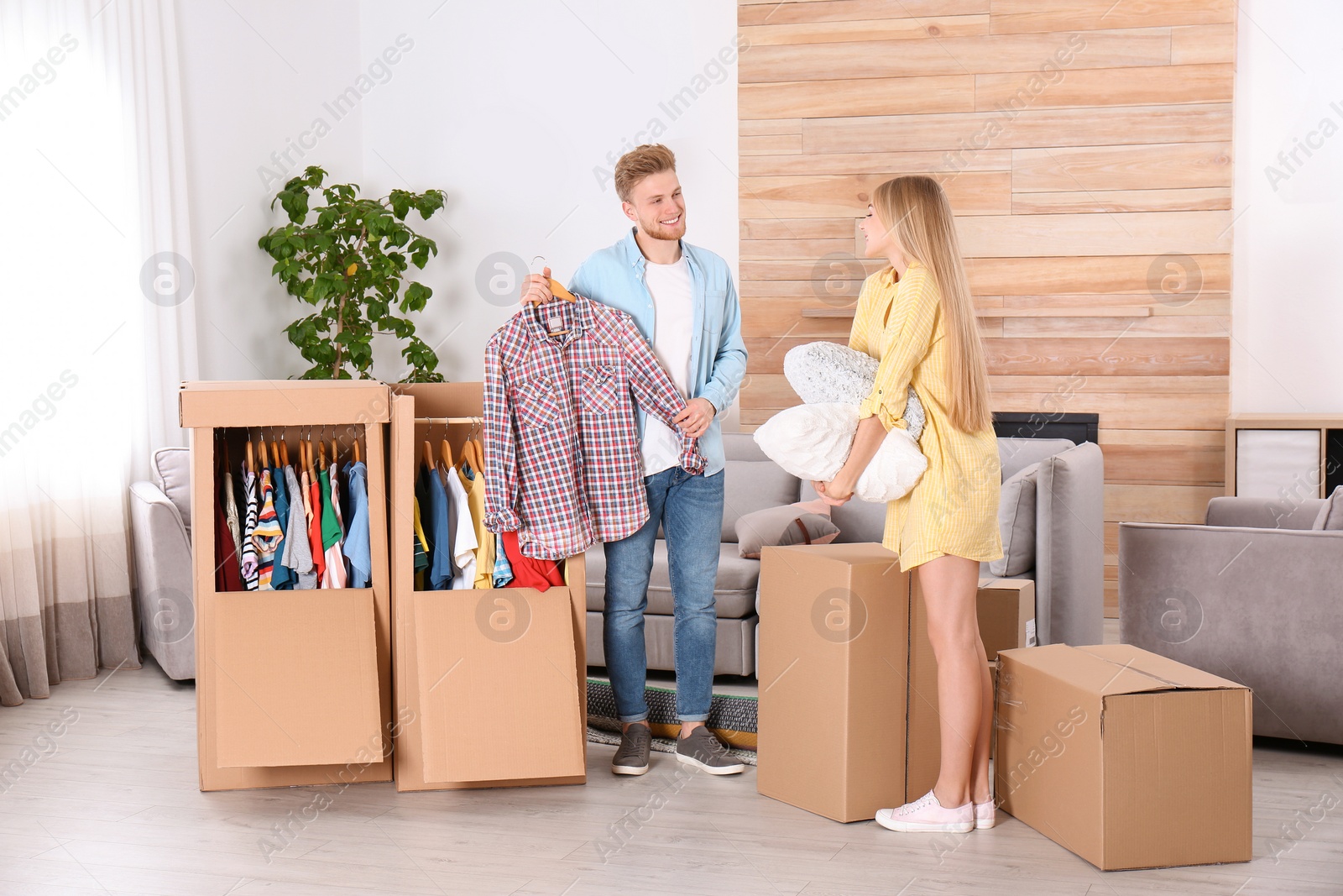 Photo of Young couple near wardrobe boxes at home