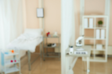 Photo of Blurred view of doctor's office interior with workplace