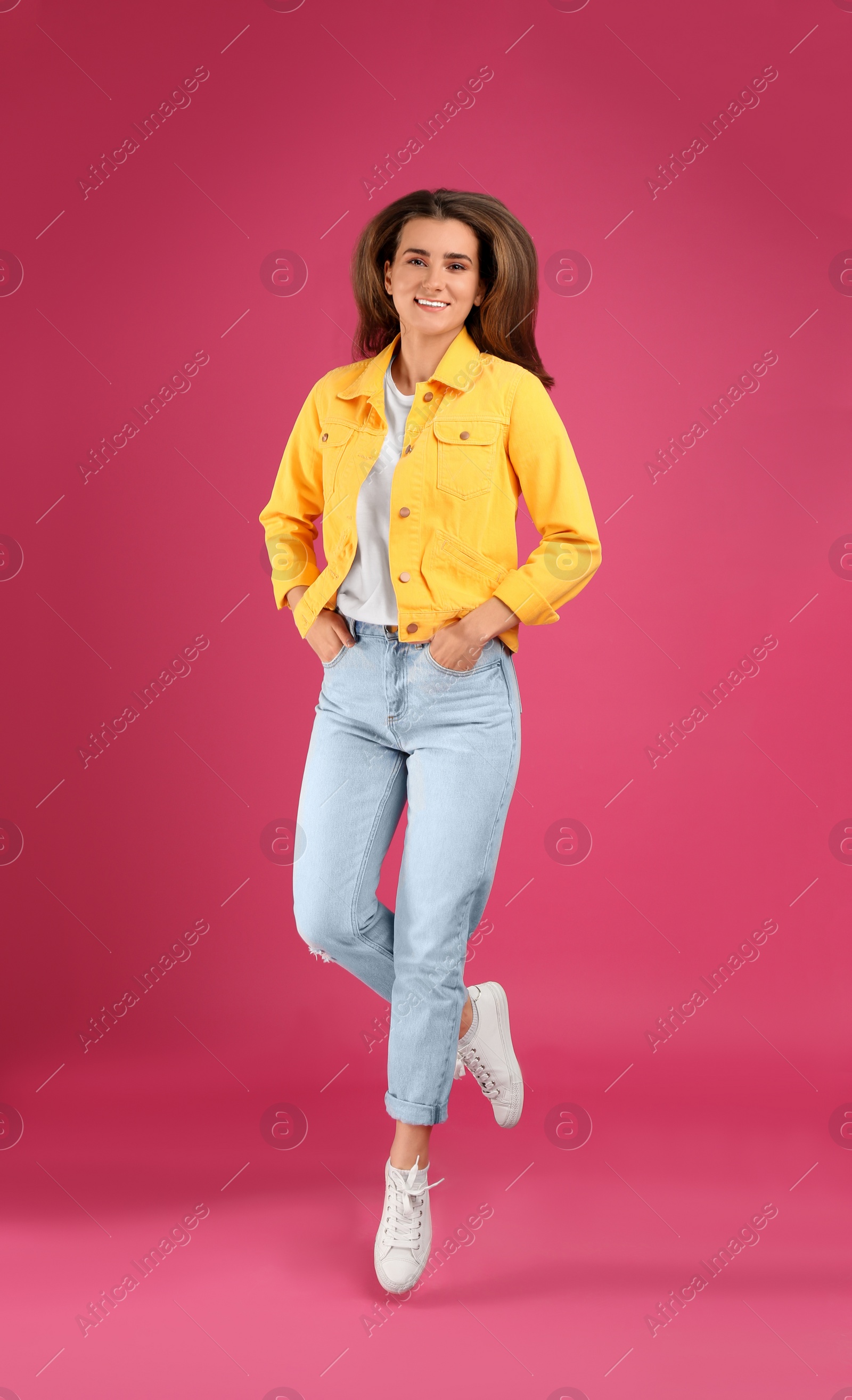 Photo of Full length portrait of beautiful young woman on pink background