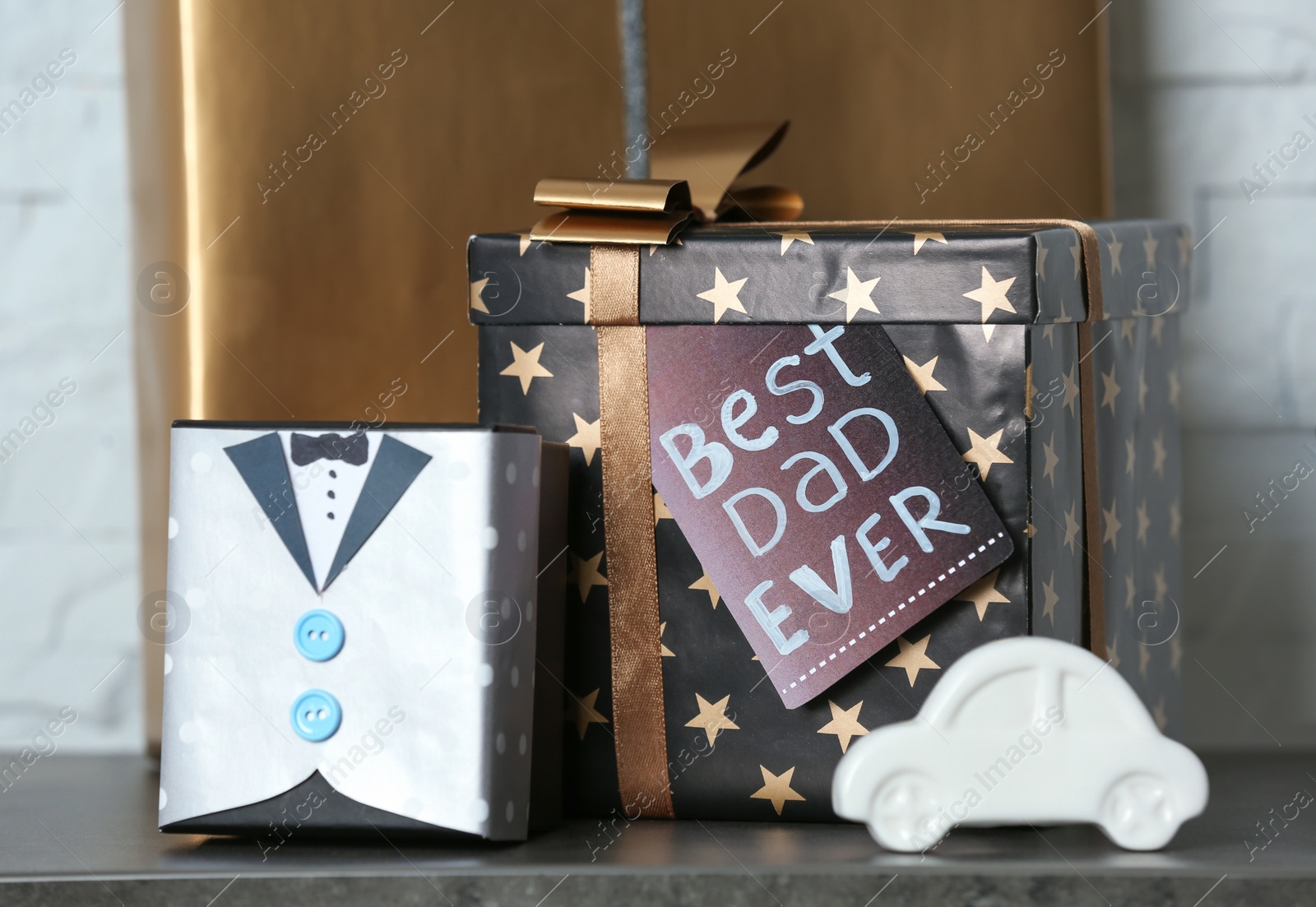 Photo of Gift boxes and toy car on table. Father's day celebration