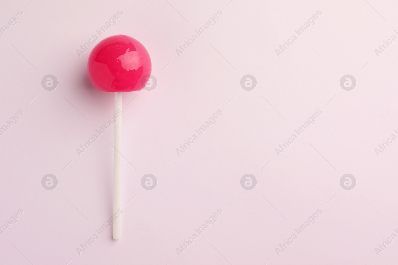 Photo of Tasty lollipop on white background, top view. Space for text