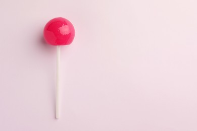 Tasty lollipop on white background, top view. Space for text