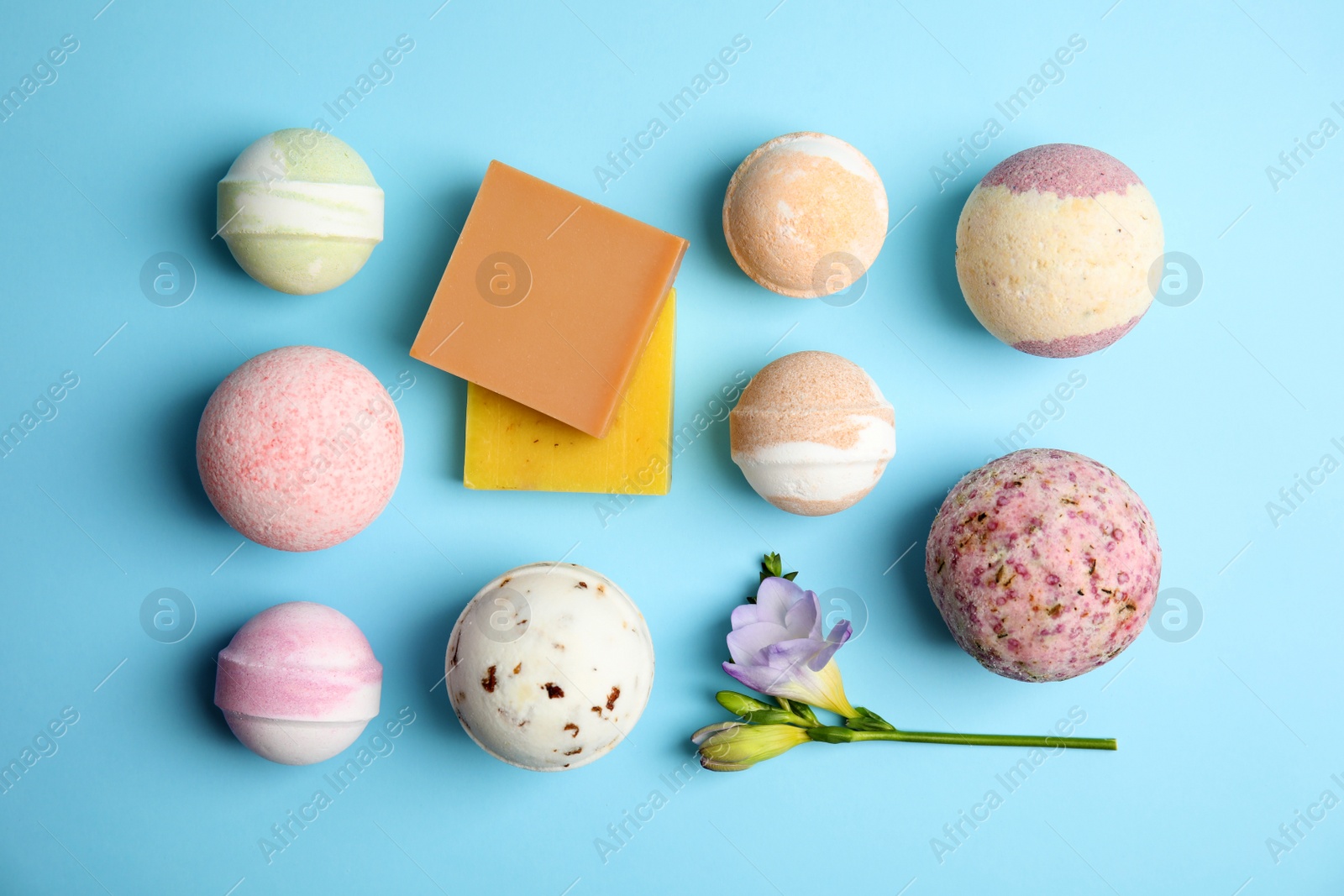 Photo of Flat lay composition with bath bombs and soap bars on color background