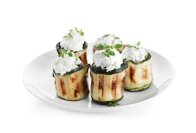 Photo of Tasty stuffed zucchini rolls on white background