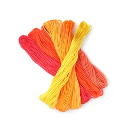 Different colorful embroidery threads on white background, top view