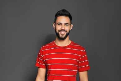 Photo of Portrait of handsome young man on gray background