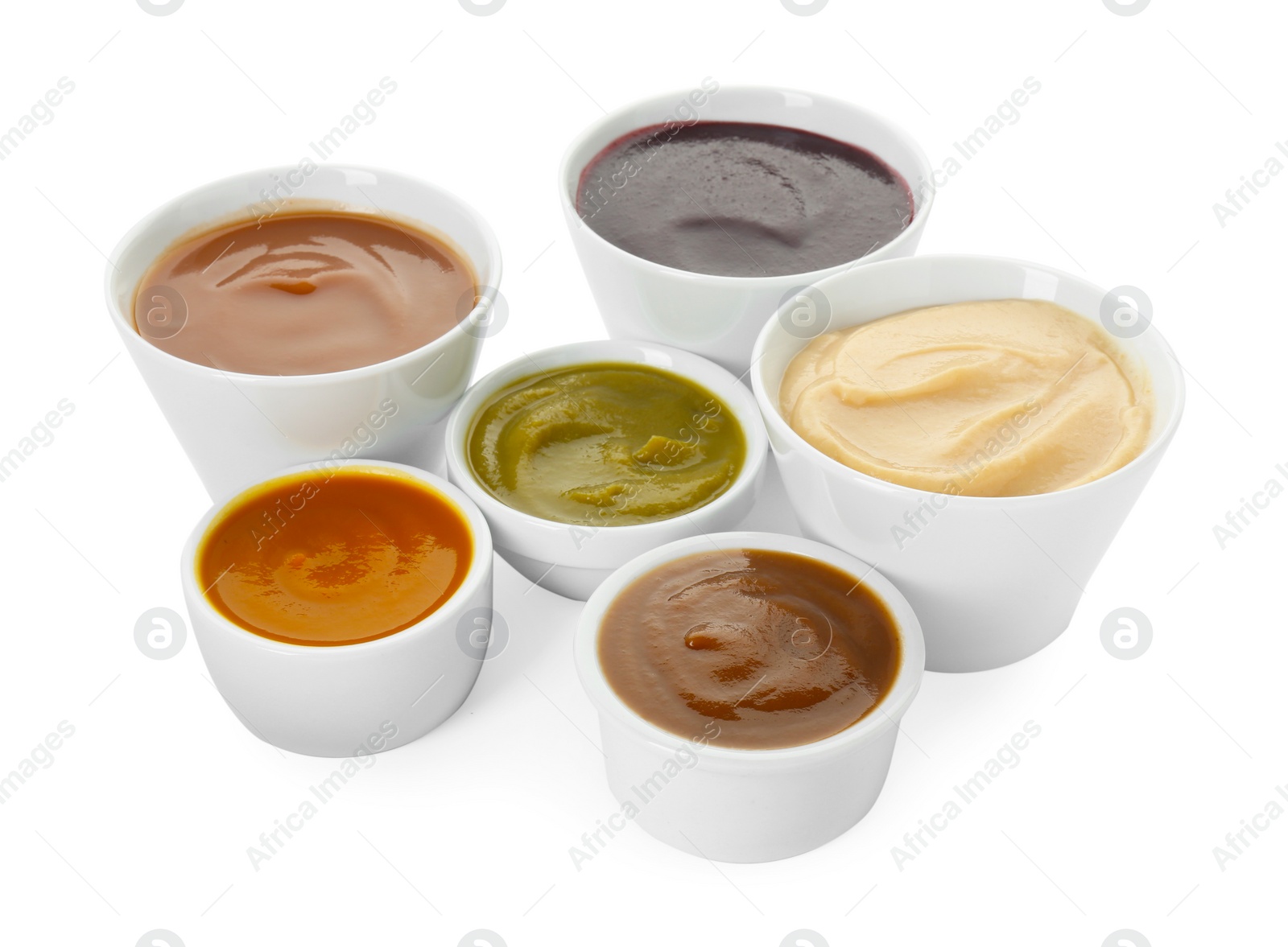 Photo of Bowls with healthy baby food isolated on white