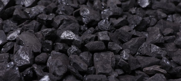 Pieces of black coal as background, closeup