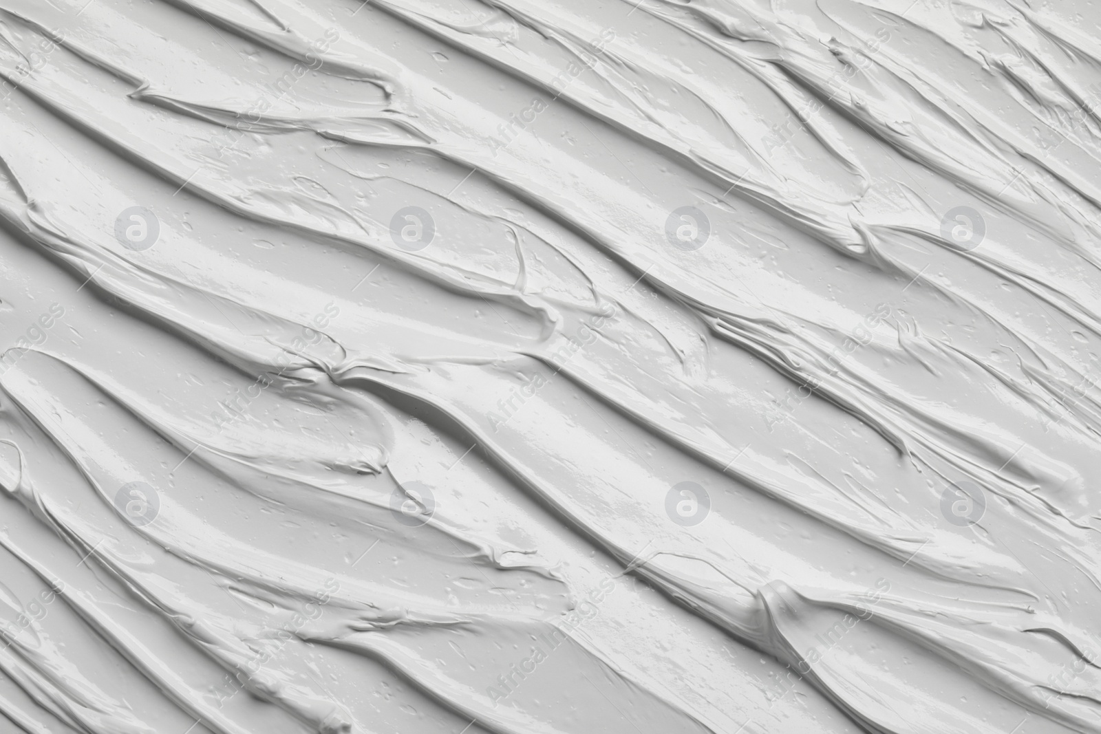 Photo of Strokes of white oil paint as background, closeup