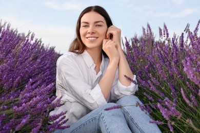 Photo of Portrait of beautiful young woman in lavender field