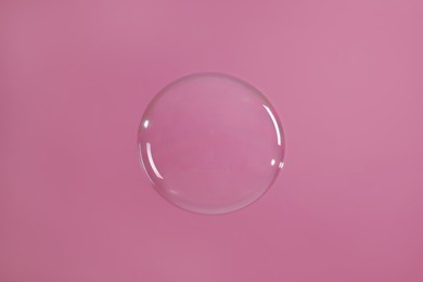 Photo of One beautiful soap bubble on pink background