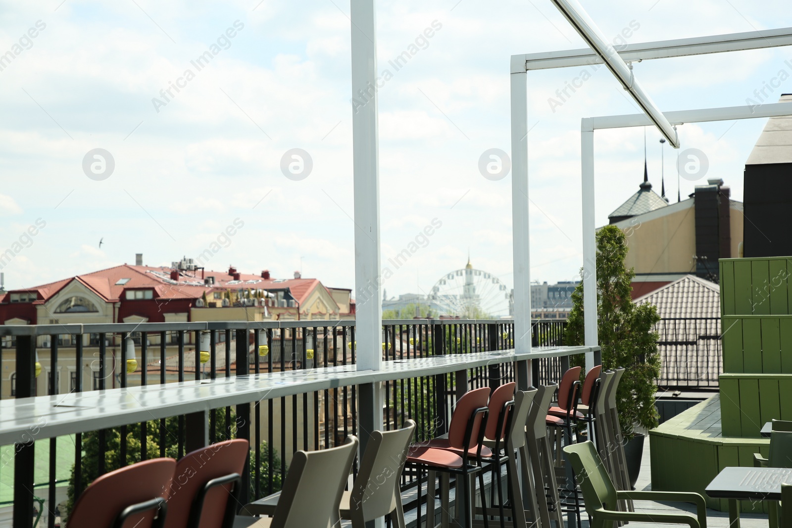 Photo of Observation area cafe. Chairs on terrace against beautiful cityscape