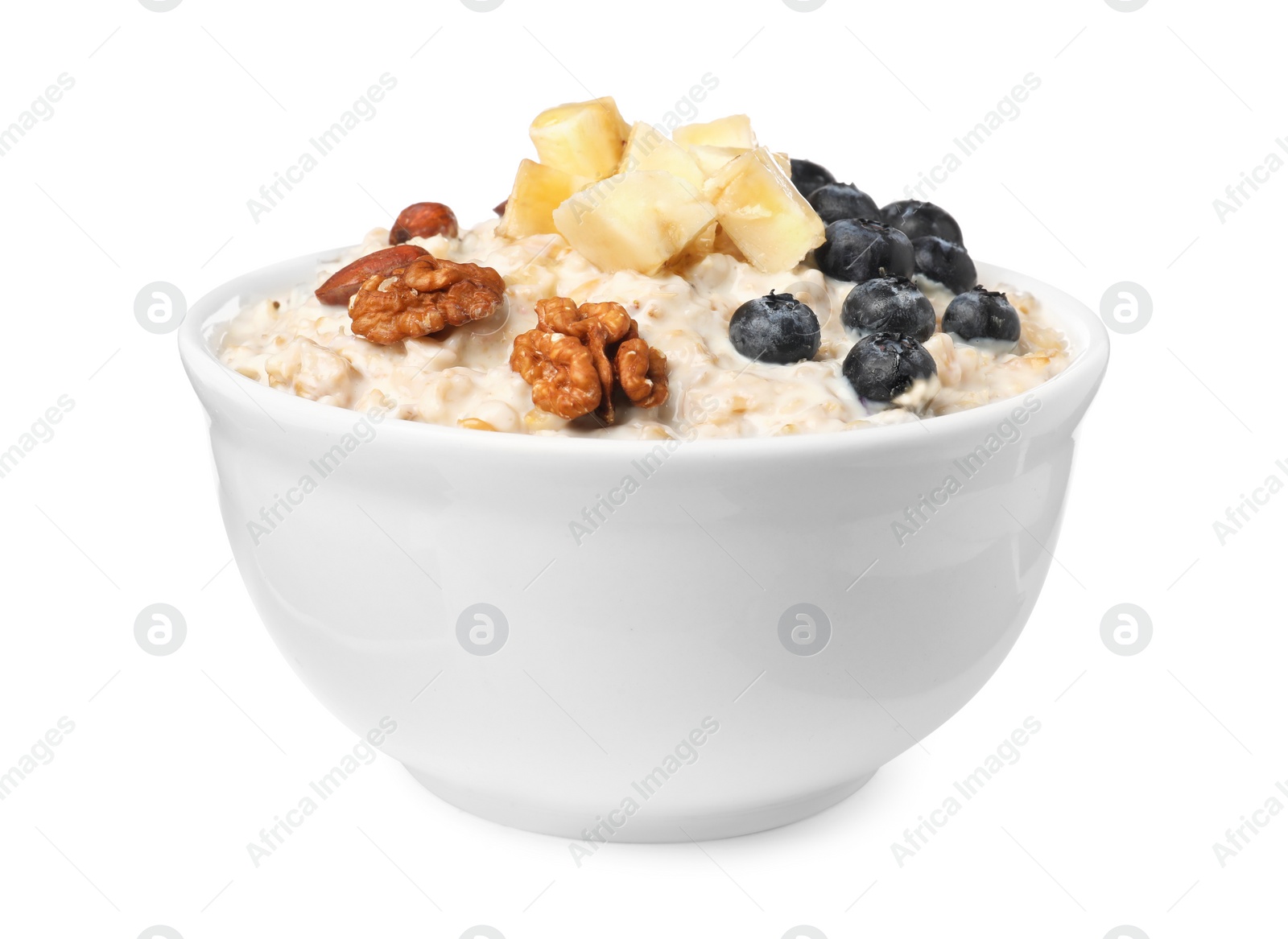 Photo of Tasty boiled oatmeal with blueberries, banana and nuts in bowl isolated on white