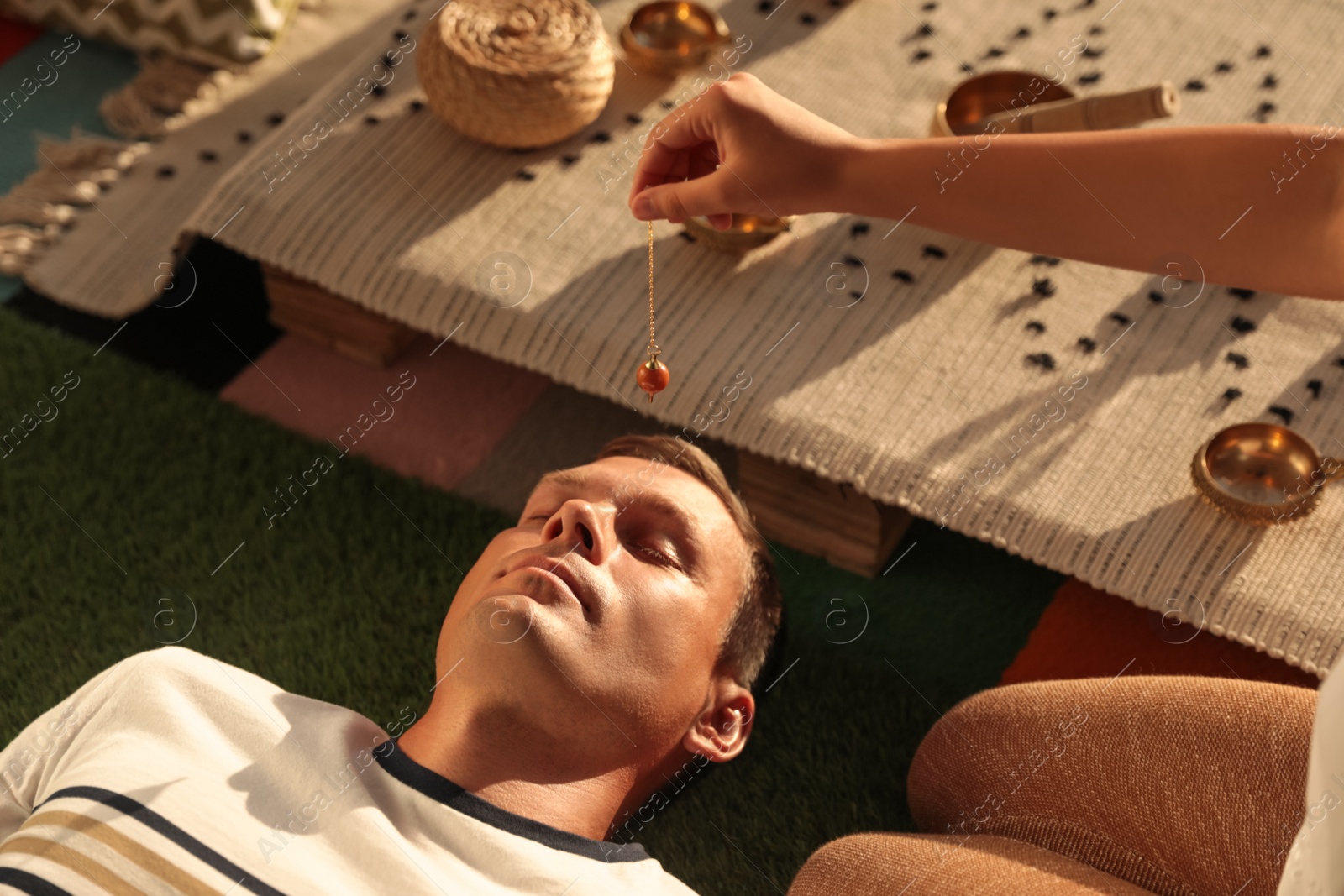 Photo of Man at crystal healing session indoors, closeup