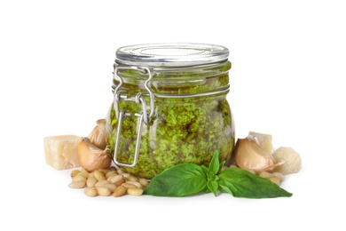 Composition with jar of tasty pesto sauce isolated on white