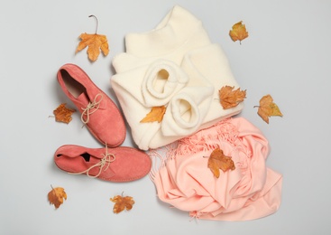Photo of Composition with warm sweater and dry leaves on white background, top view. Autumn season