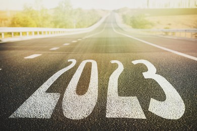 Start new year with fresh vision and ideas. 2023 numbers on asphalt road