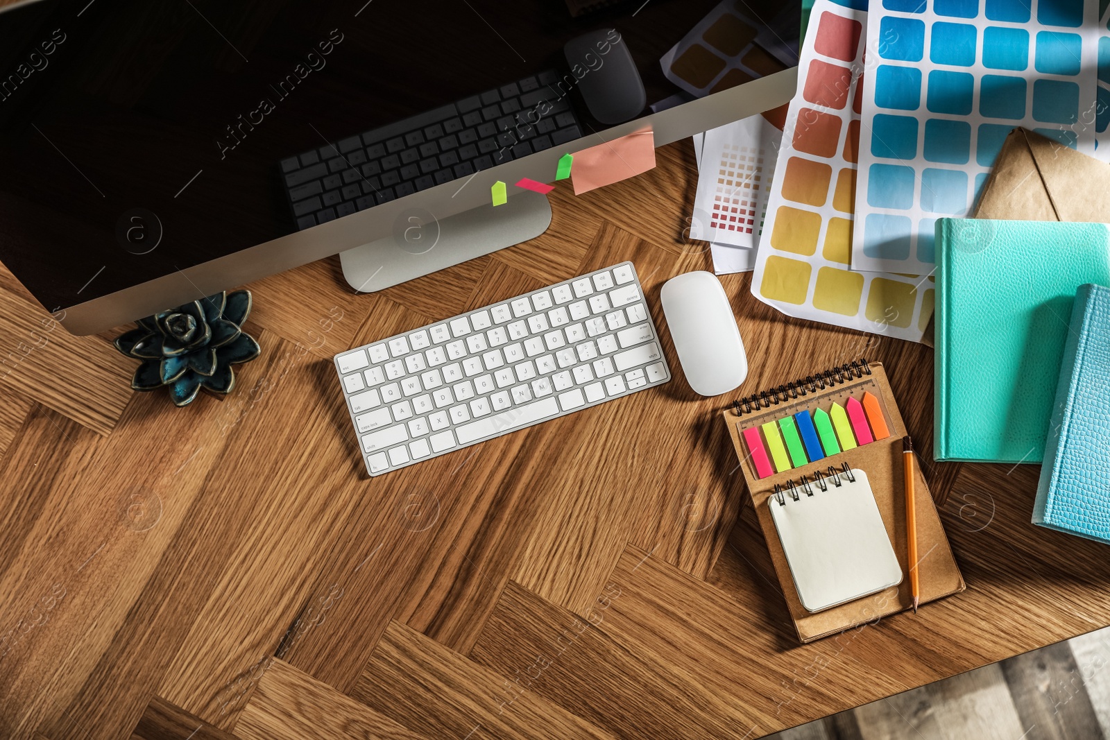 Photo of Designer's workplace with modern computer and color palettes, flat lay. Space for text