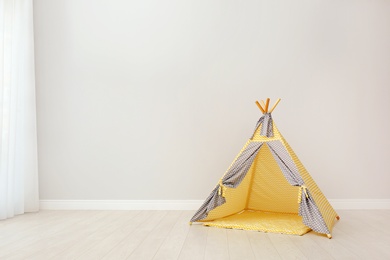 Play tent for kids near white wall with space for text