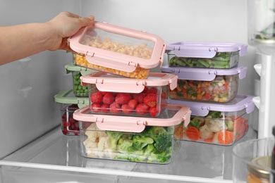 Woman taking box with corn kernels from refrigerator, closeup