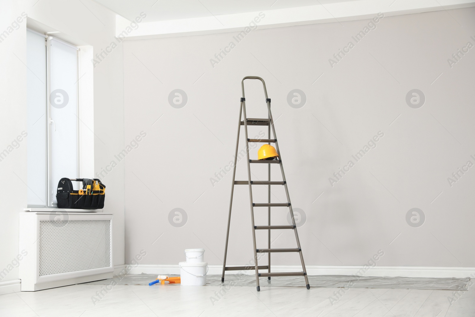 Photo of Ladder, decorator's tools and box with instruments in room