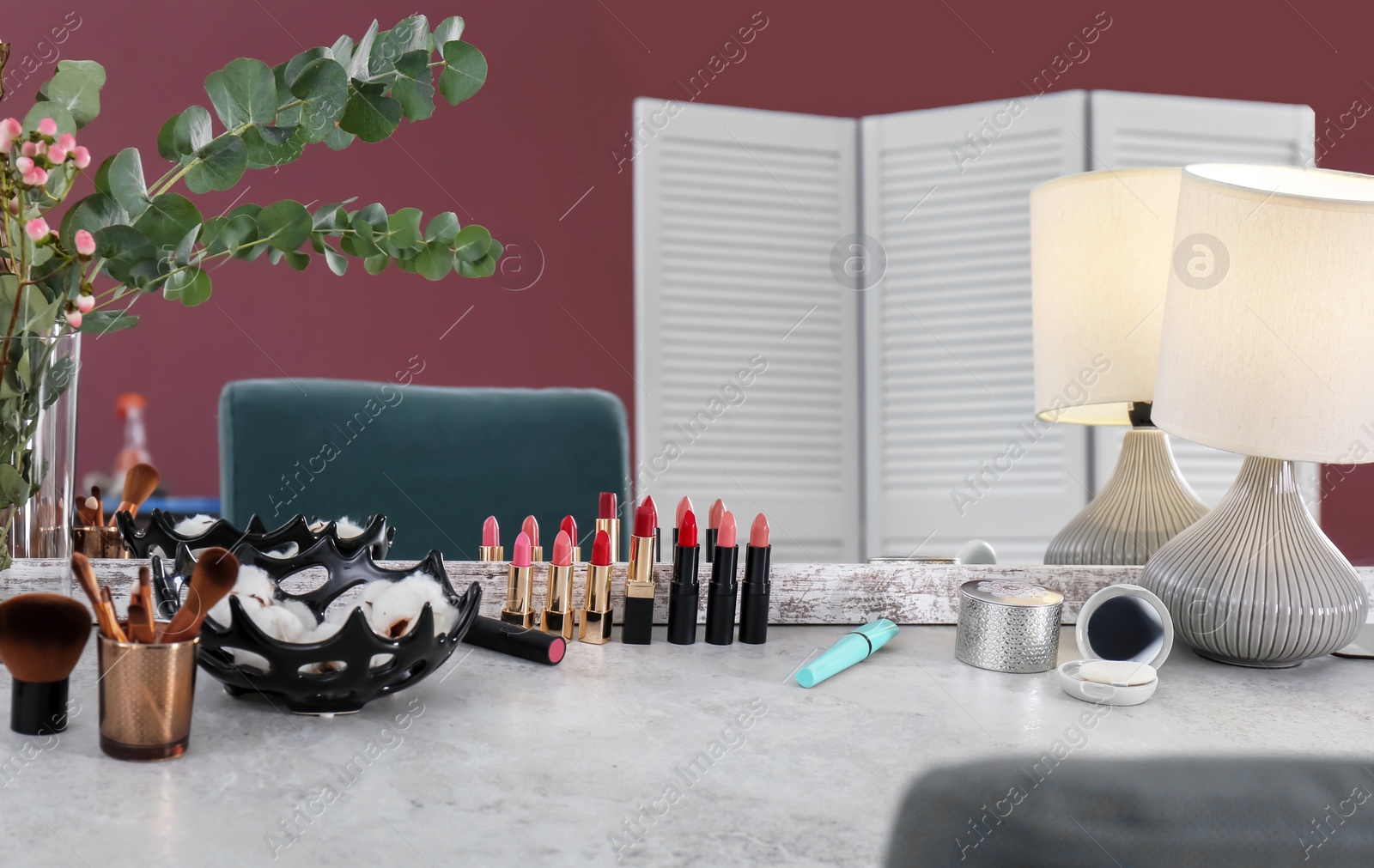 Photo of Decorative cosmetics and tools on dressing table near mirror in makeup room