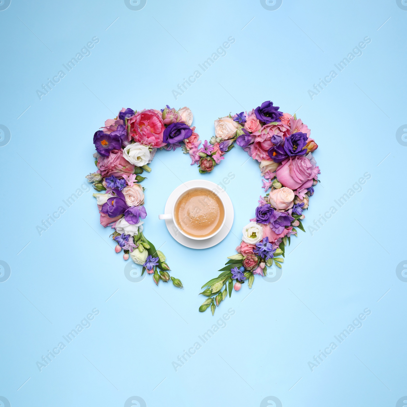 Photo of Beautiful heart shaped floral composition with cup of coffee on turquoise background, flat lay