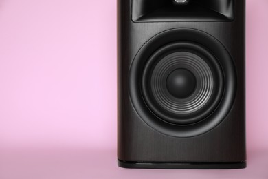 One wooden sound speaker on pink background, closeup. Space for text