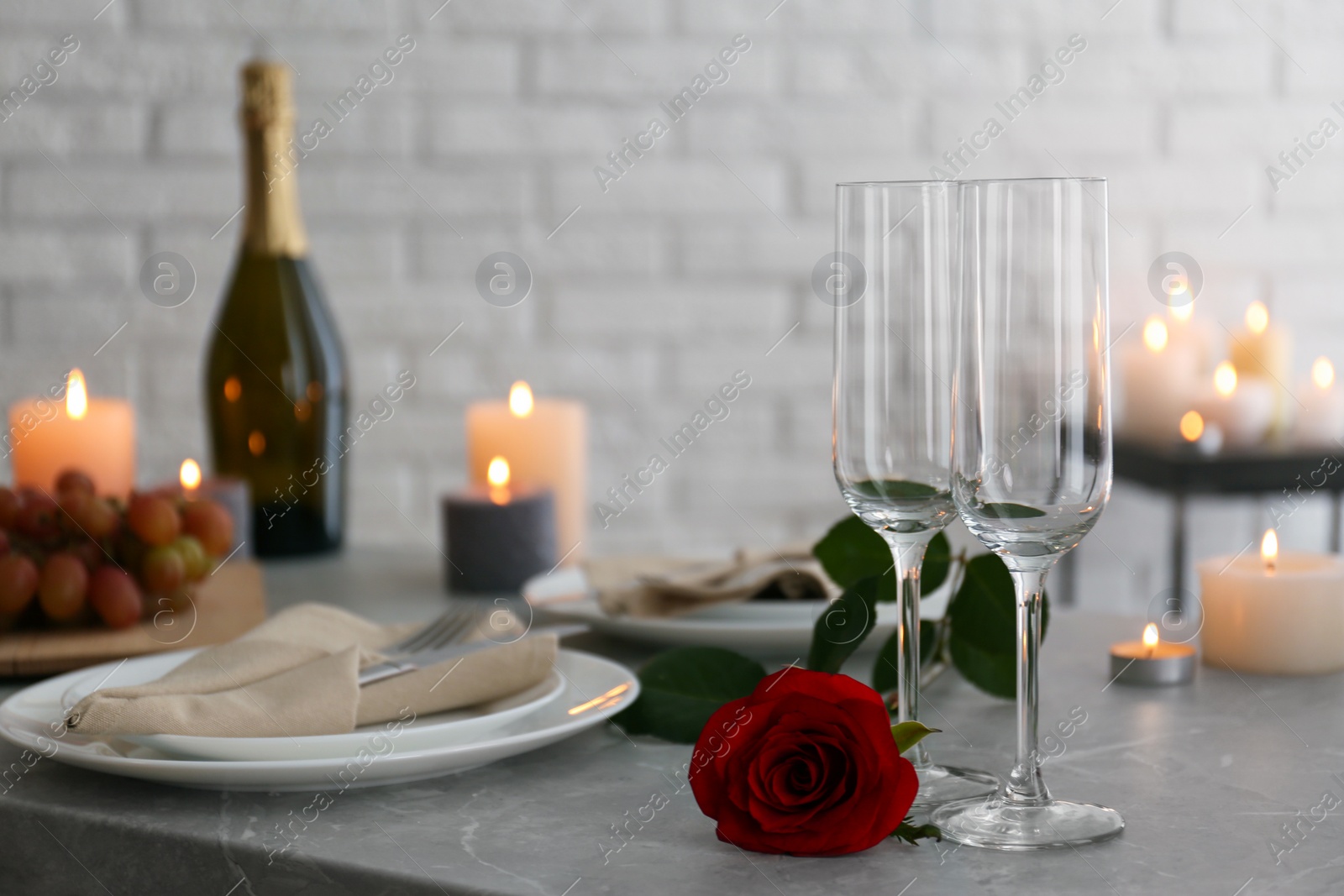 Photo of Romantic table setting with burning candles indoors