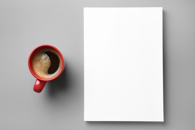 Blank paper sheets for brochure and cup of coffee on grey background, flat lay. Mock up