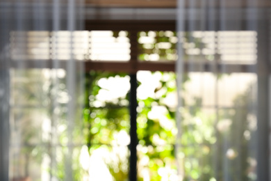 Photo of Blurred view through window on garden in morning