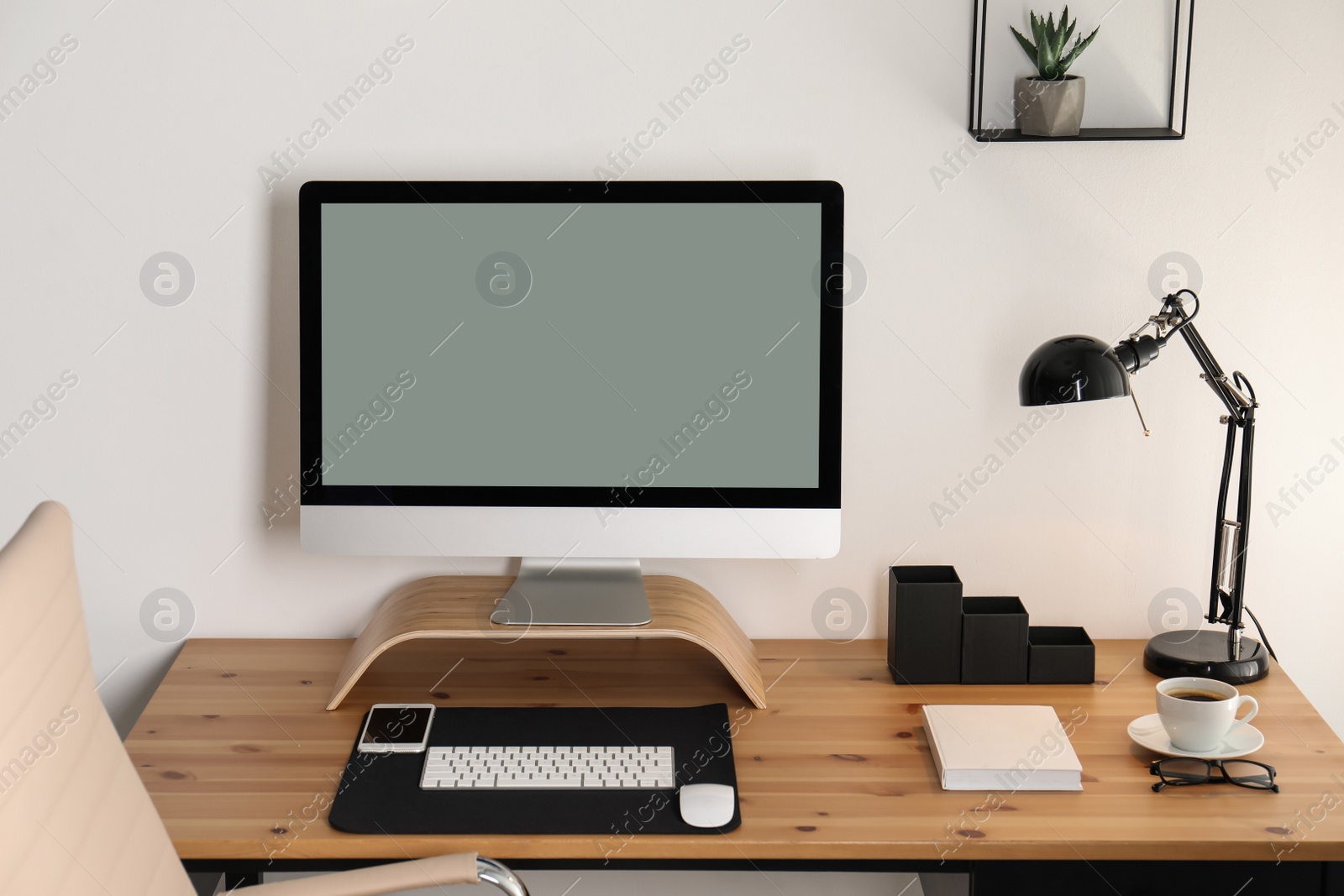 Photo of Stylish workplace interior with modern computer on table. Mockup for design