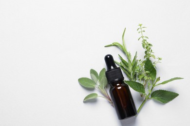 Photo of Bottle of essential oil, different herbs and flowers on white background, flat lay. Space for text