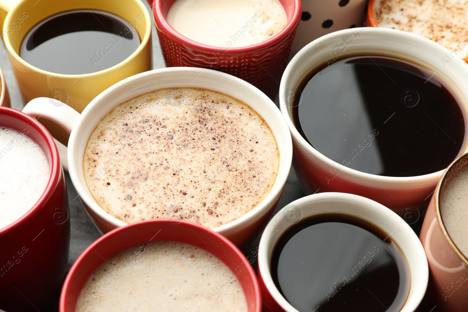 Photo of Many cups of different coffees on table, closeup