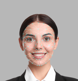 Image of Facial recognition system. Young woman with biometric identification scanning grid on grey background