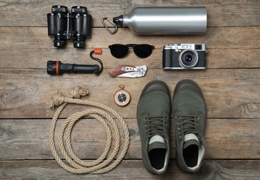 Flat lay composition with different safari accessories on wooden background