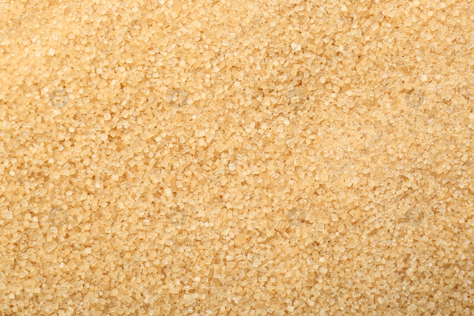 Photo of Granulated brown sugar as background, top view