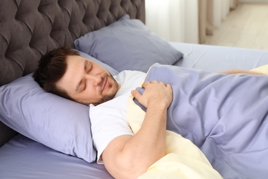 Handsome man sleeping on pillow at home. Bedtime