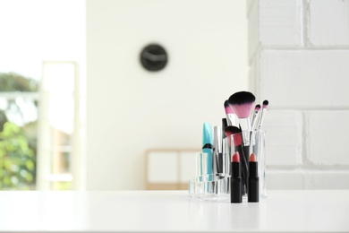 Organizer with makeup cosmetic products on table indoors. Space for text