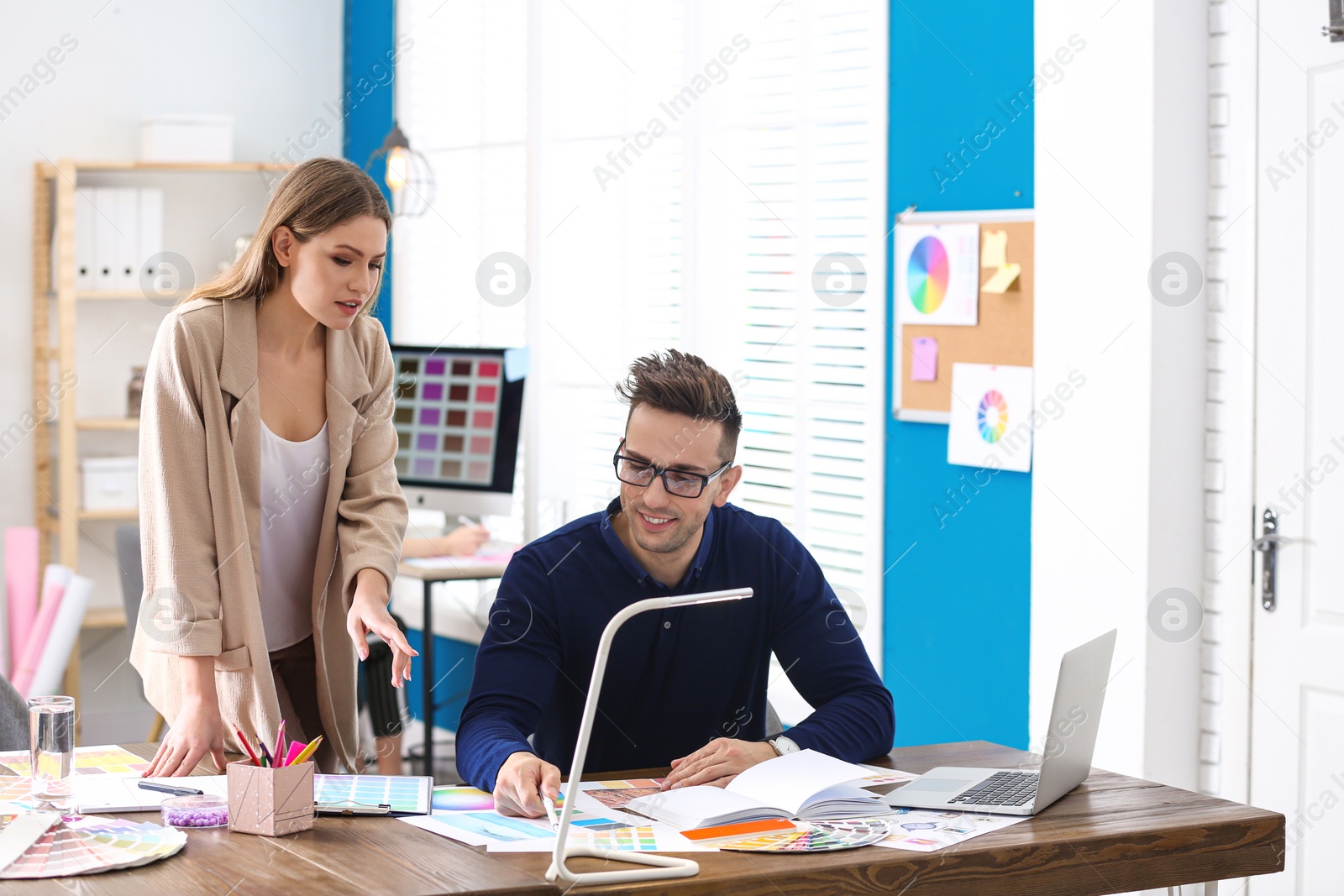 Photo of Professional interior designer with colleague working in office