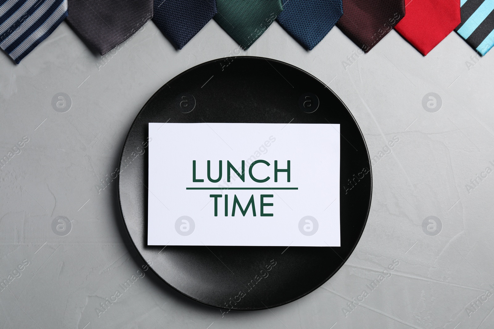 Image of Business lunch. Card with phrase Lunch Time, plate and different ties on light gray table, flat lay