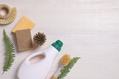 Photo of Flat lay composition with different cleaning supplies on light wooden background, space for text