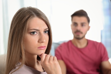 Photo of Young couple with relationship problems in living room