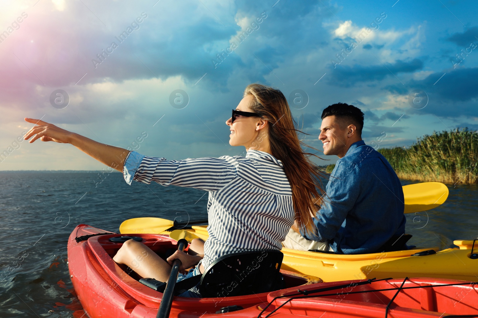 Photo of Beautiful couple kayaking on river. Summer activity