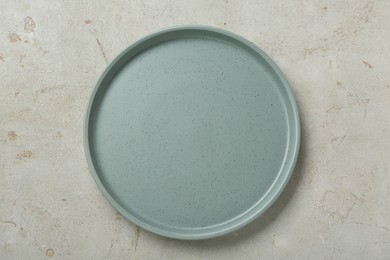 Photo of Empty ceramic plate on light grey table, top view