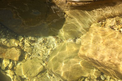 Photo of Beautiful clean pond and rocks as background, top view