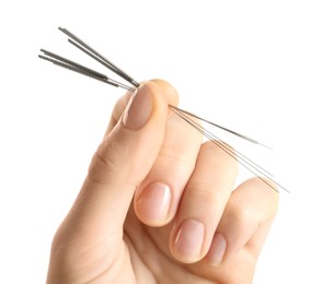 Photo of Woman holding needles for acupuncture on white background, closeup
